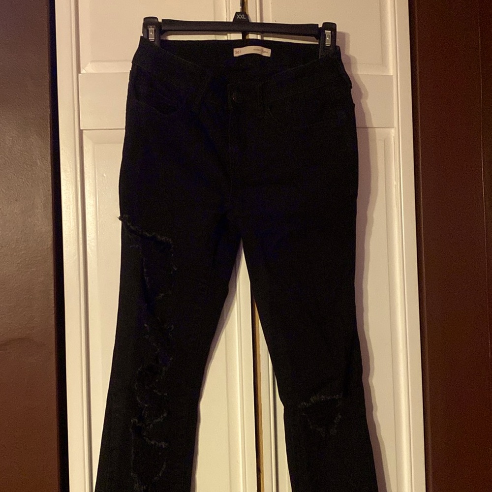 SO black jeans with manufactured rips in the legs and knees.